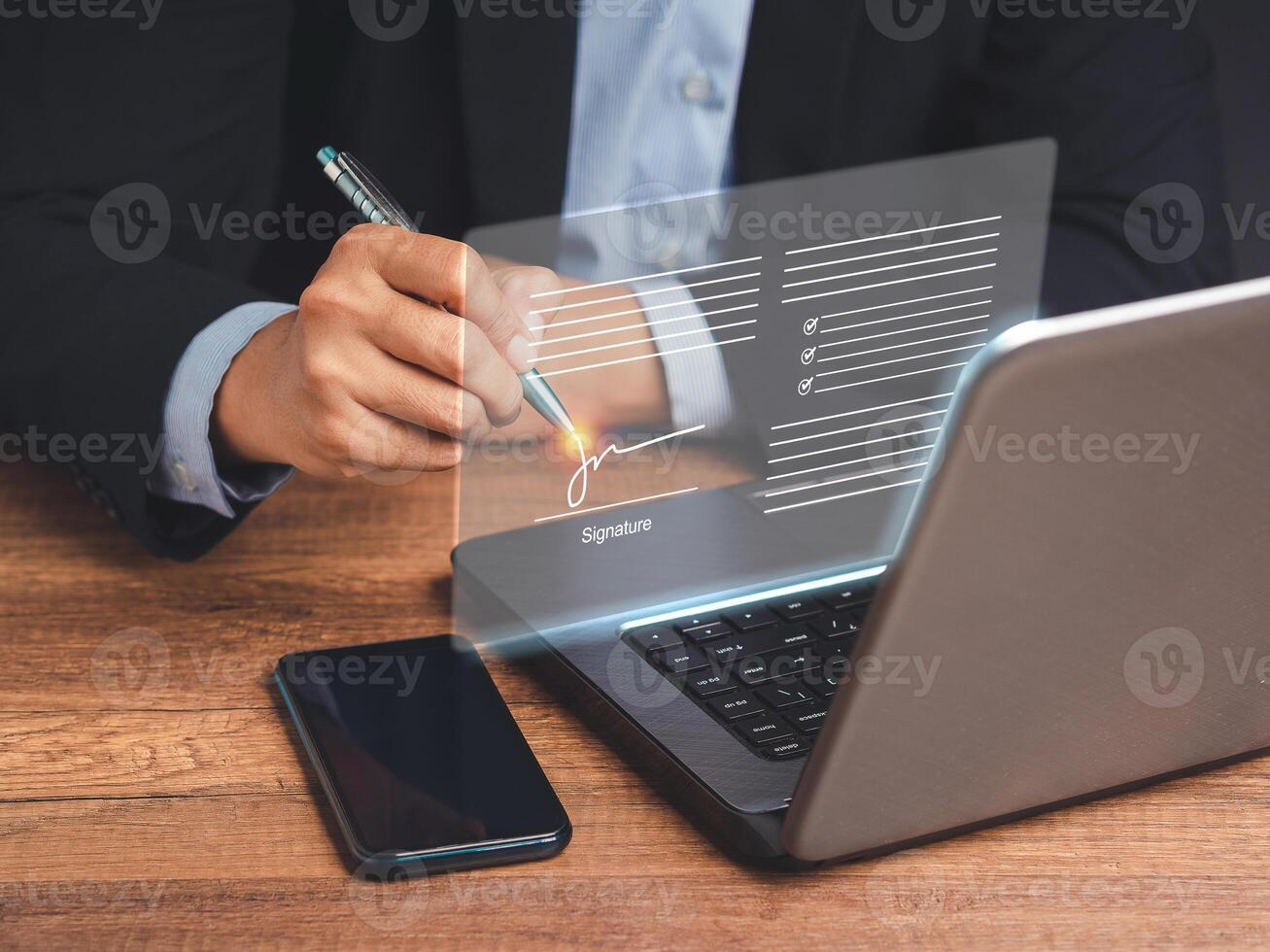 Electronic signature. A businessman in a suit uses a pen to sign electronic documents on digital documents on a virtual screen photo