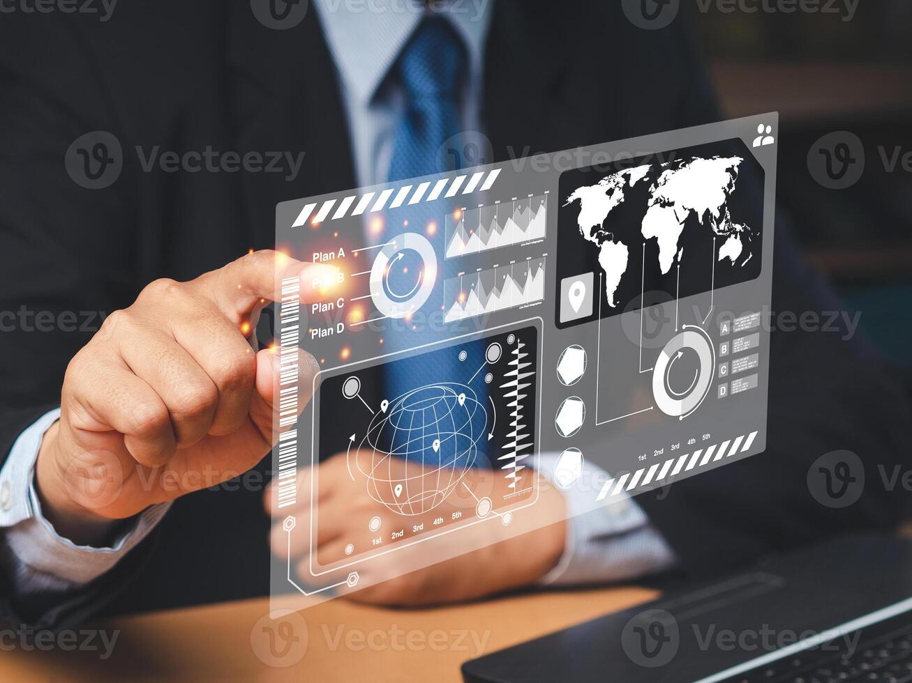 Businessman in a suit point at the report on a virtual screen while sitting in the office photo