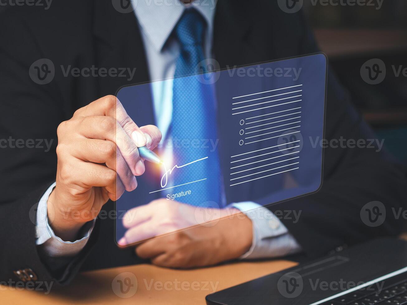 Electronic signature. A businessman in a suit uses a pen to sign electronic documents on digital documents on a virtual screen photo