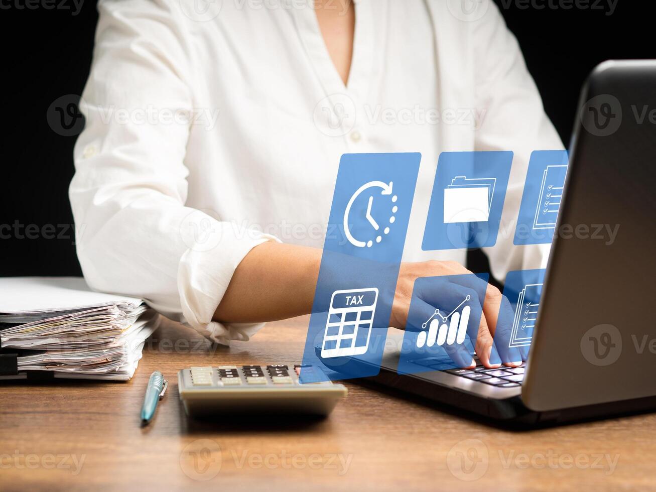 A businesswoman uses a tax form to complete an individual income tax payment form on a virtual screen photo