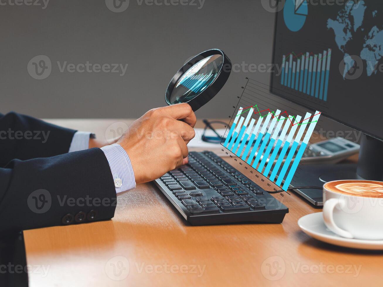 Businessman looking at statistical information comparing data in charts graph with a magnifying glass on a virtual screen while sitting in the office photo