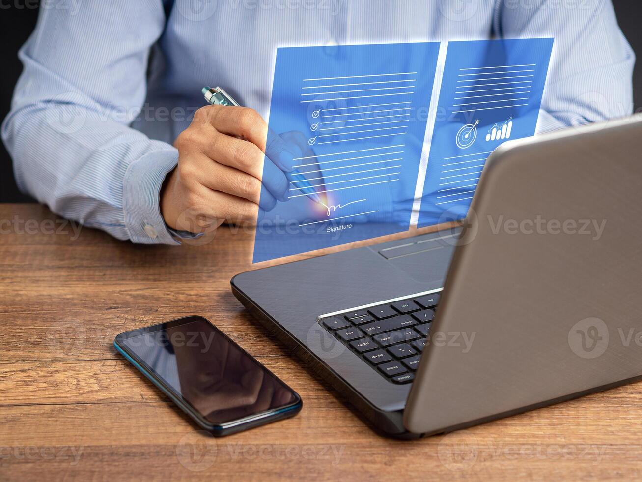 A businesswoman uses a pen to sign electronic documents on digital documents on a virtual screen photo