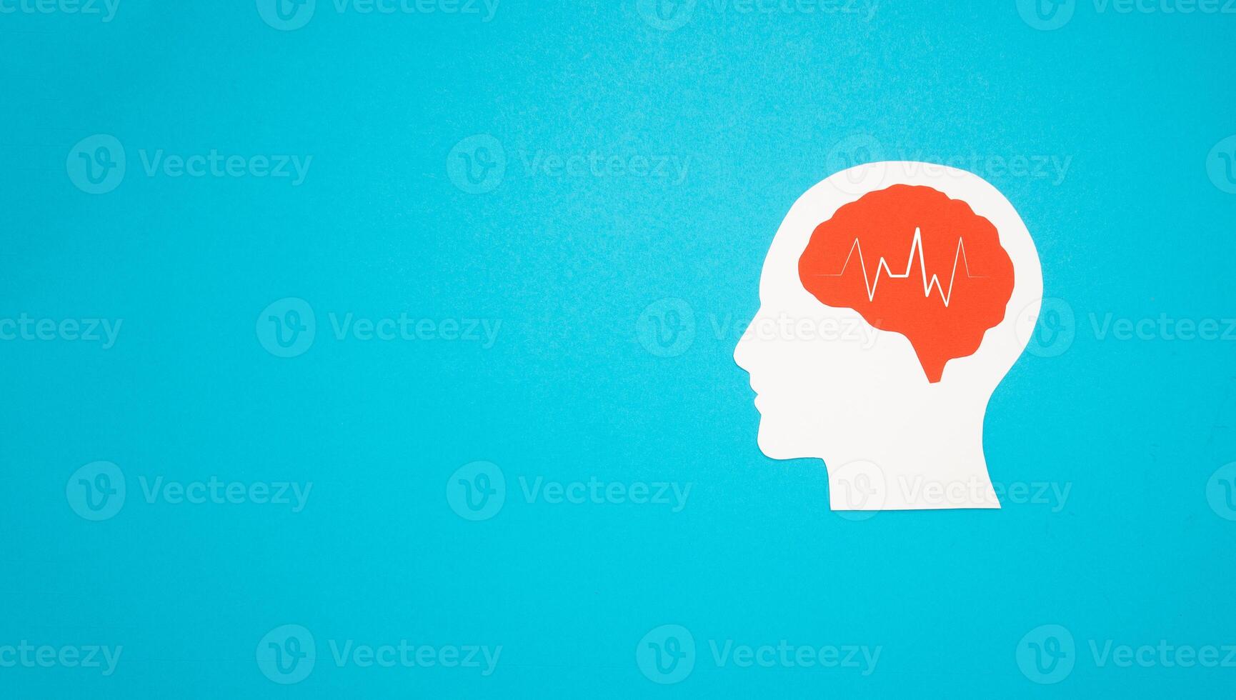A brain shape made from paper on a light blue background photo