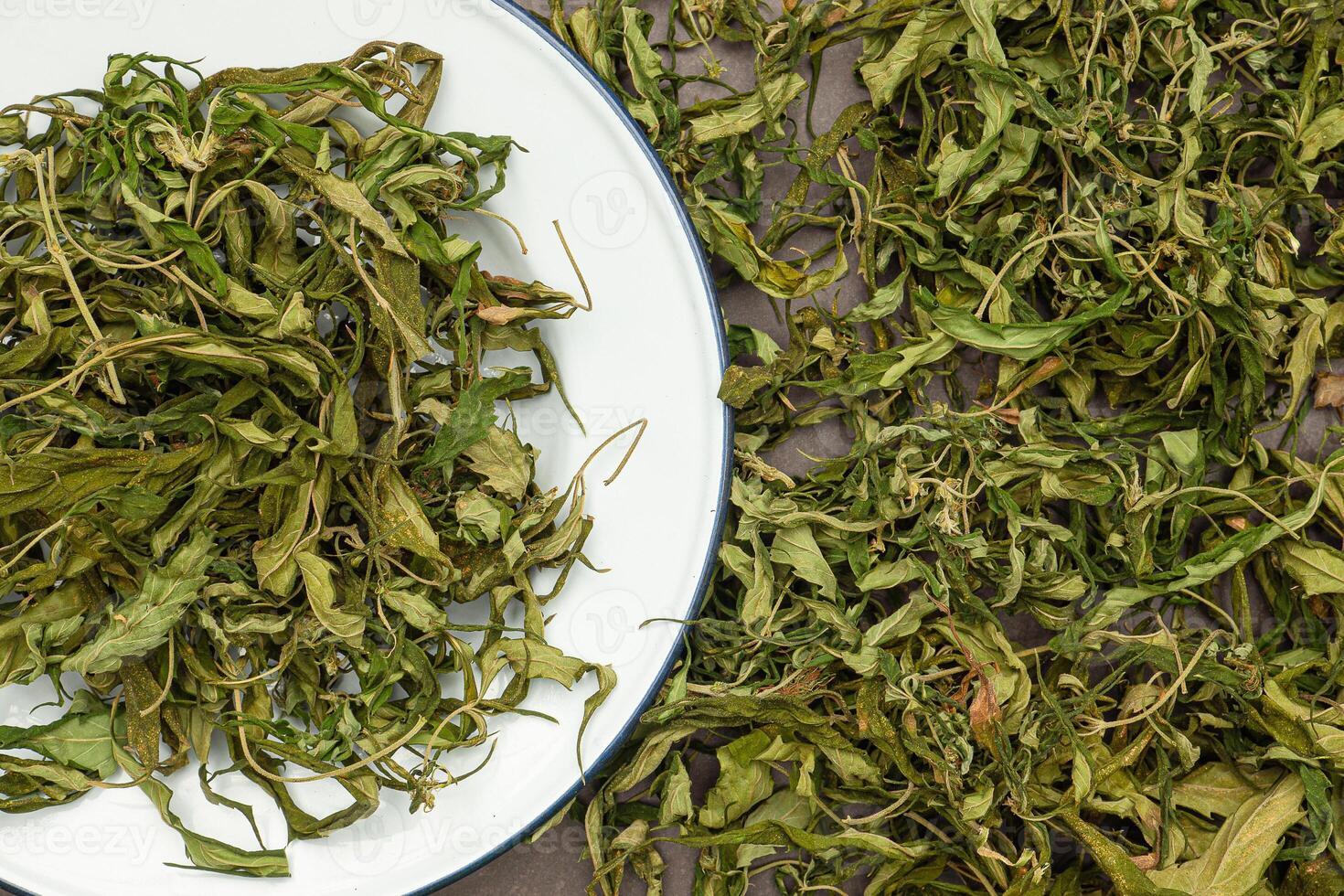 Top view of dry cannabis leaf tea. Textured marijuana leaves photo