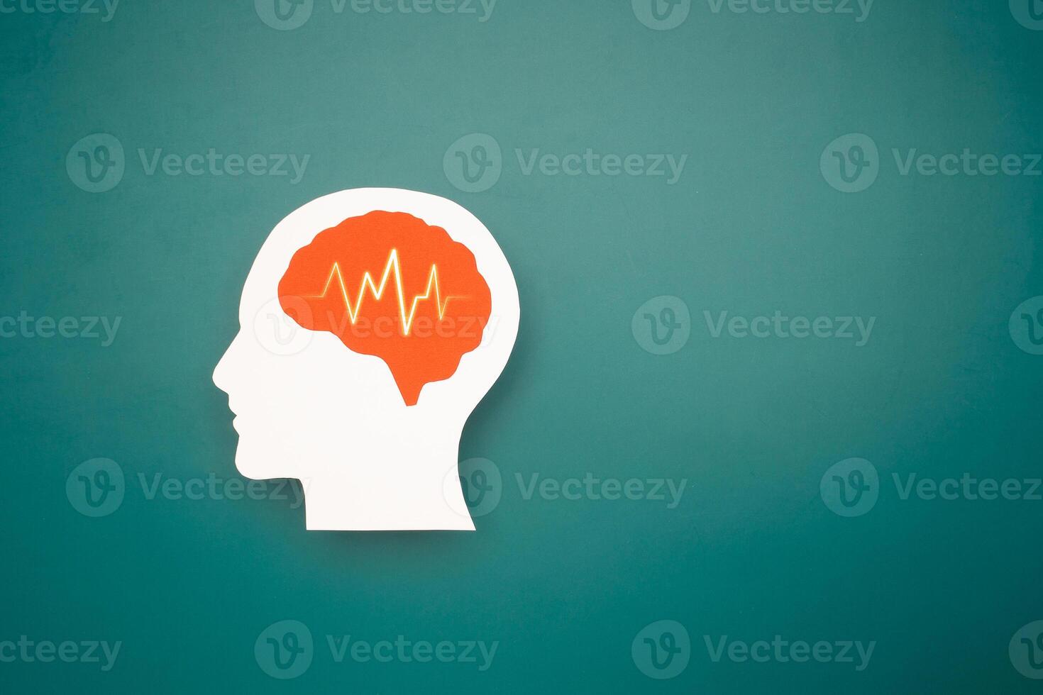 A brain shape made from paper on a green background photo