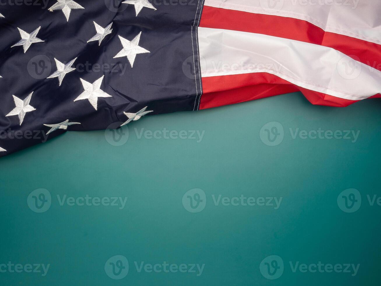 Top view of the American flag on a green background with copy space for text photo