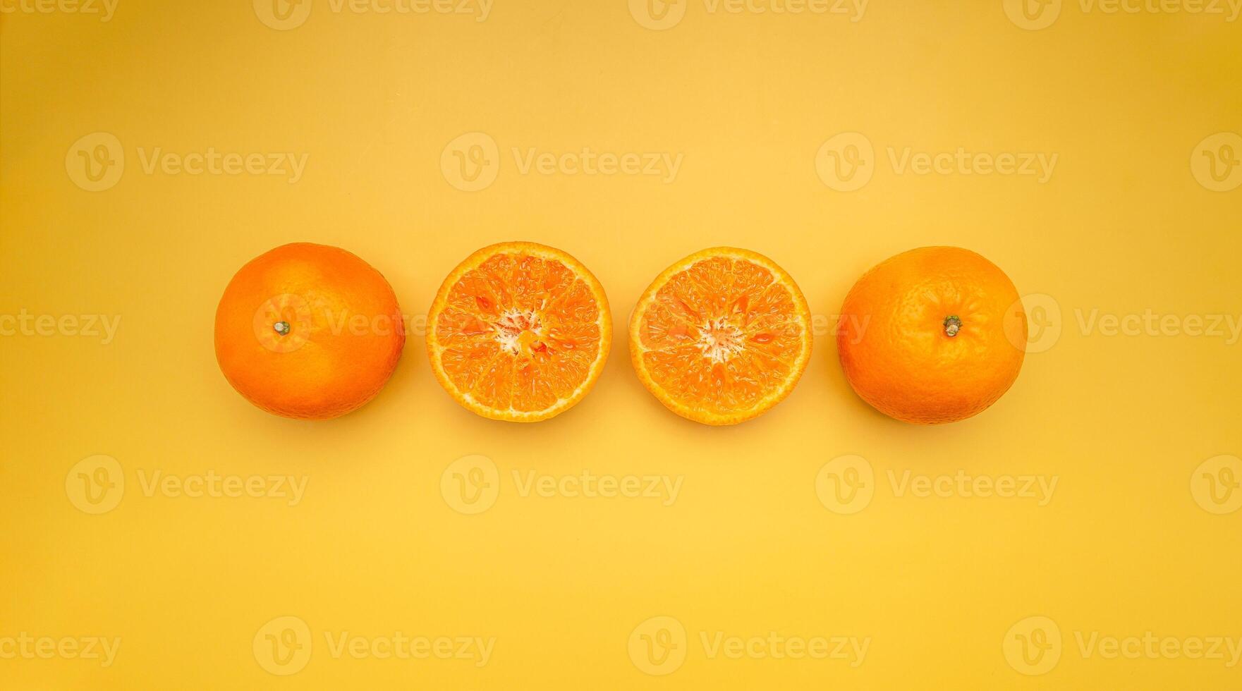 Top view of oranges is on a yellow background photo