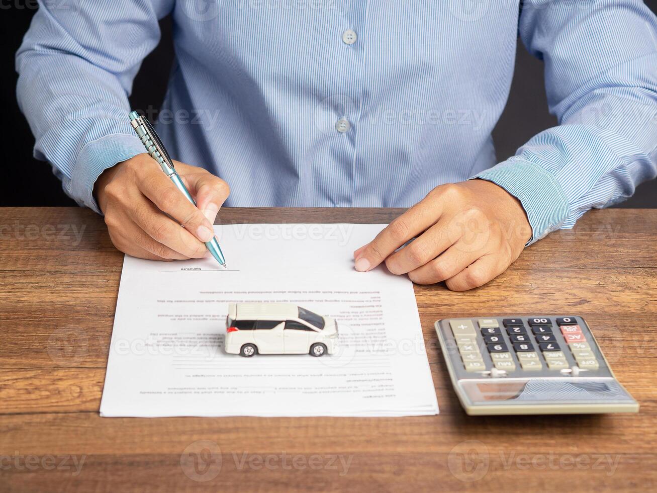 Close-up of female signing lease paper contract or agreement or car insurance document photo