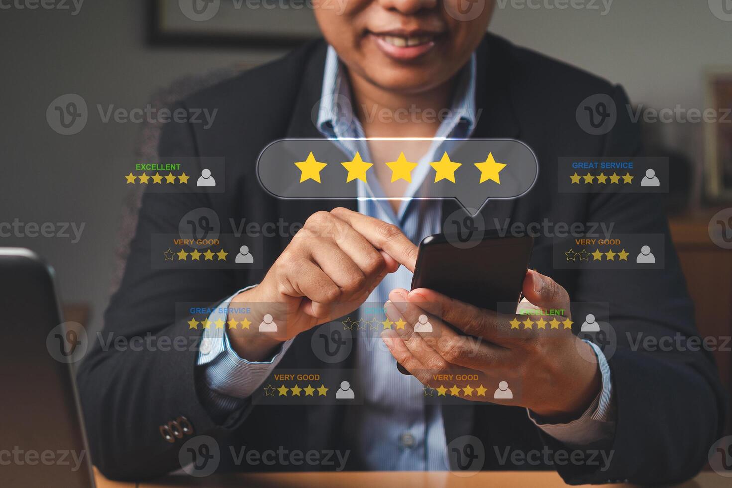 A businesswoman using a smartphone gives the five-star icon a rating of very impressed for service photo