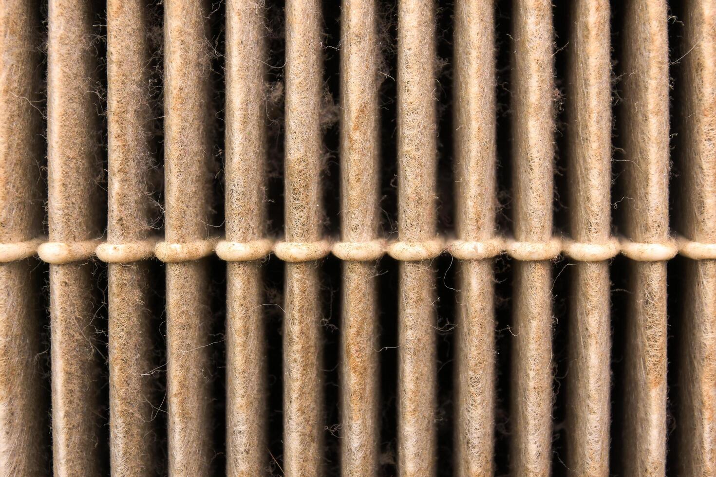 Close up of dusty air filter material of car , car air filter clogged , Car maintenance concept photo