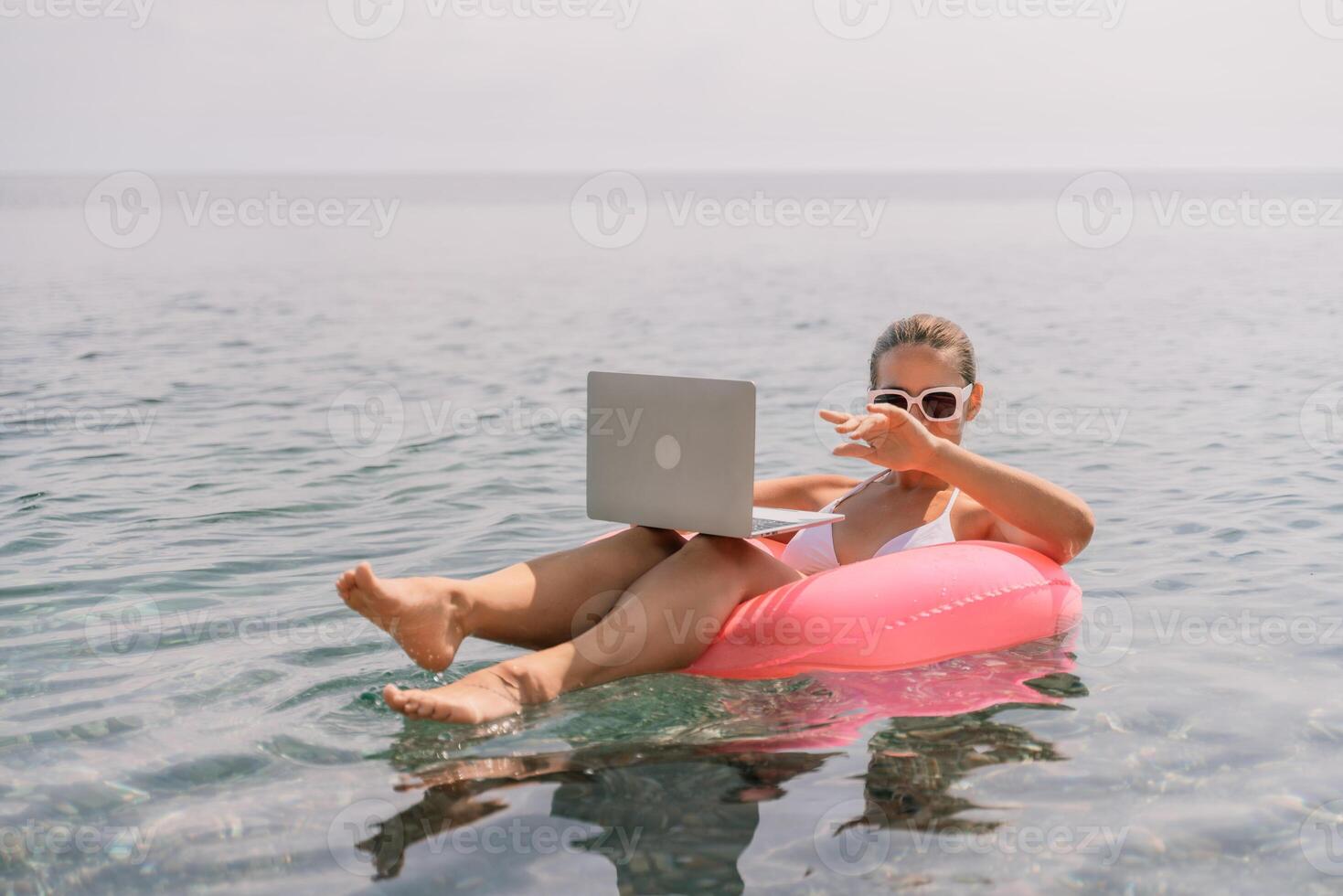 Freelance close up woman hands writing on computer. Well looking middle aged woman typing on laptop keyboard outdoors with beautiful sea view. photo