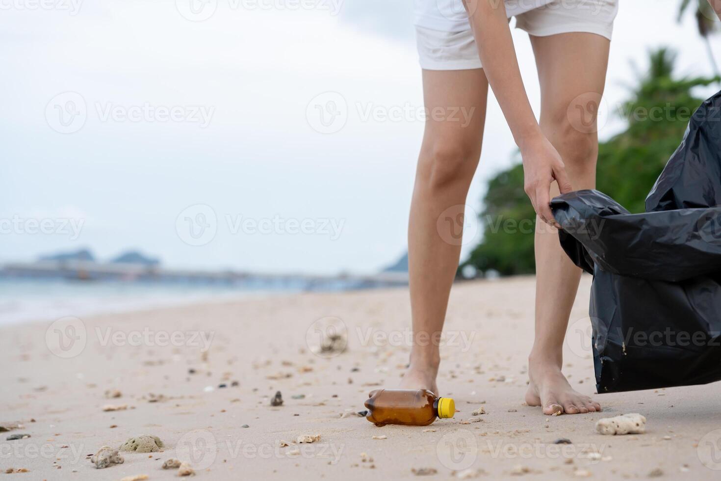 Save ocean. Volunteer pick up trash garbage at the beach and plastic bottles are difficult decompose prevent harm aquatic life. Earth, Environment, Greening planet, reduce global warming, Save world photo