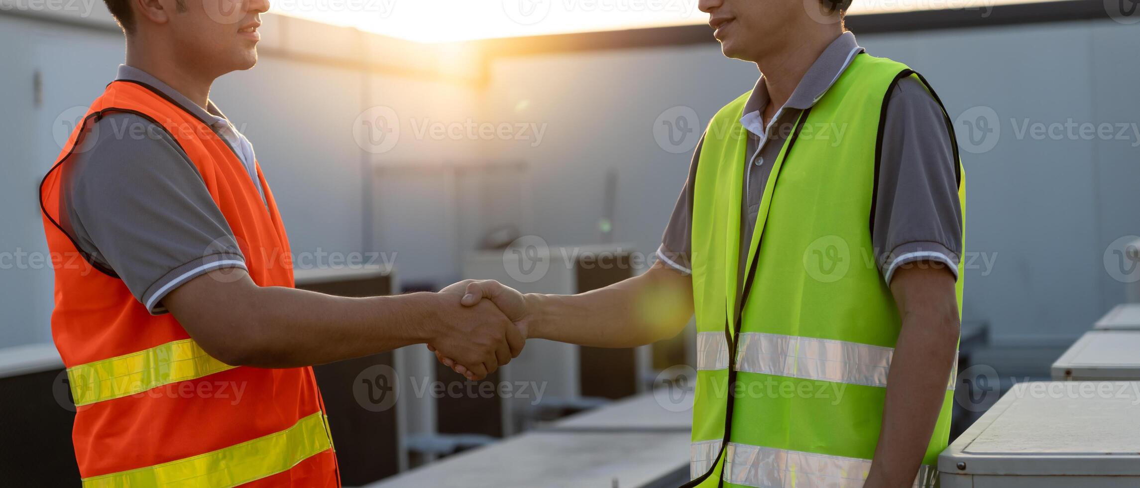 Engineers team shake hand after install air condition systems on site. Contractor and inspector inspection construction during project. civil Forman check quality assurance control. Audit, inspect photo