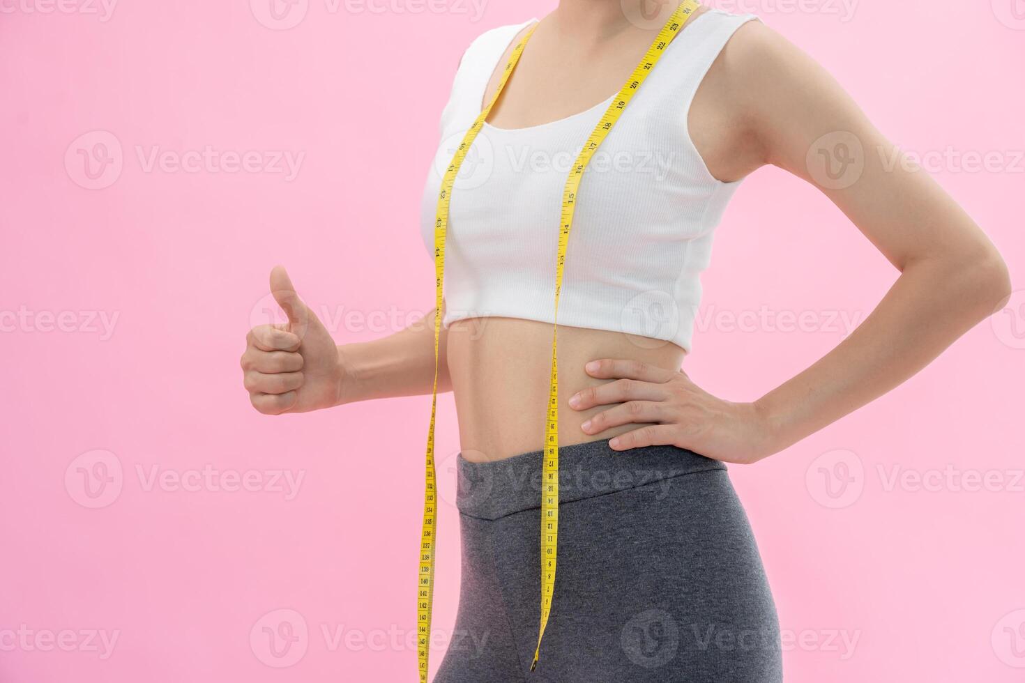 women happy results of diet. Beautiful shape. female have a reduced waist size after under going a weight loss corse. can not wear jean due to weight loss. balance, control, routines, exercise. photo