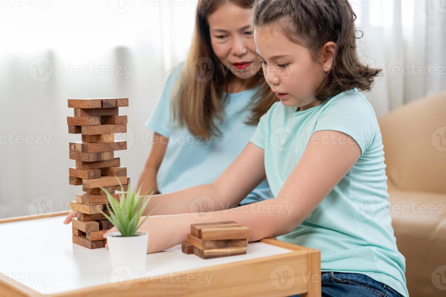 Asia Happy mother playing learning games jan-ga with the little girl. Funny family is happy and excited in the house. mother and son having fun spending time together. holiday, weekend, vacant. photo
