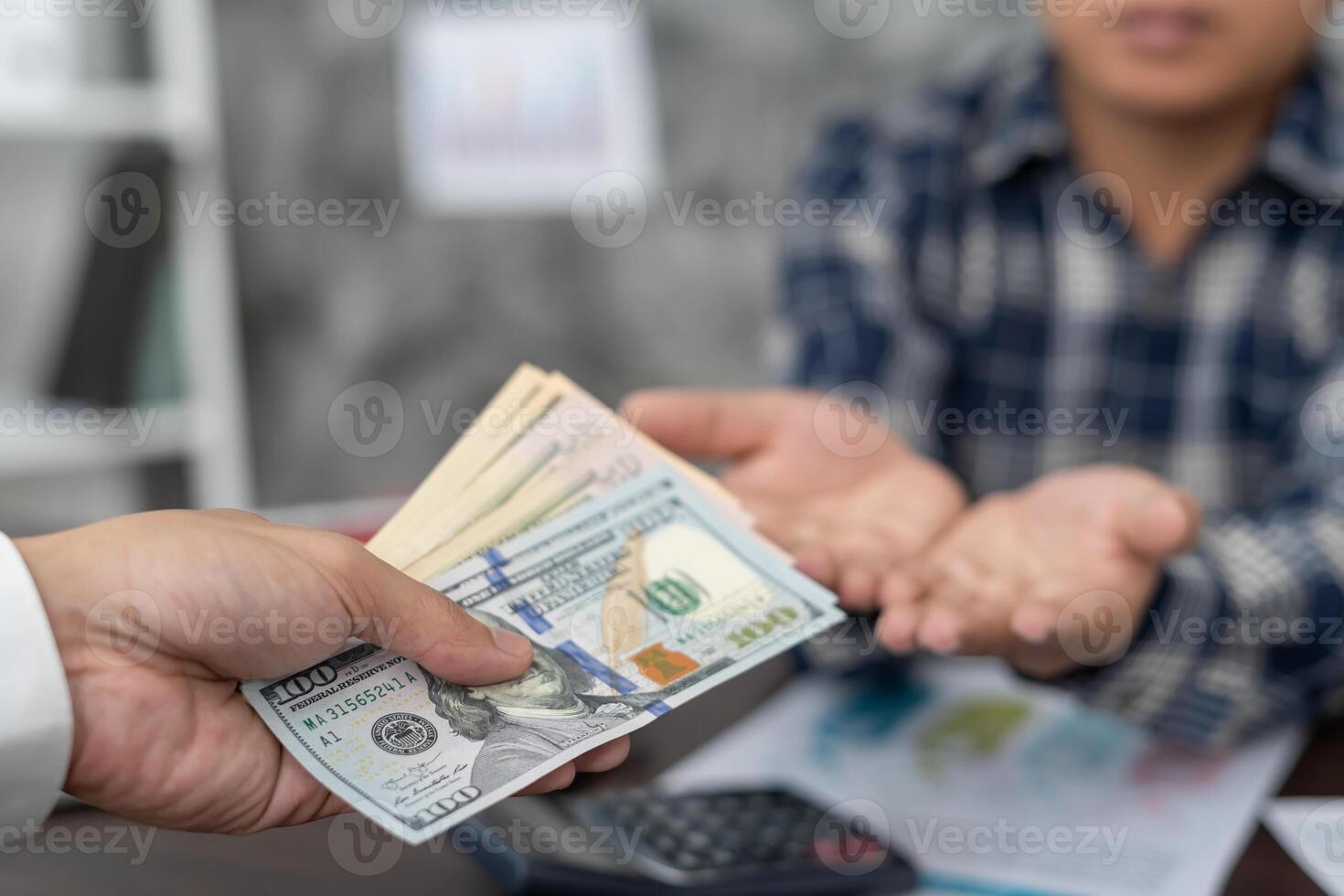 Businessmen receive salary or bonuses from management or Boss. Company give rewards to encourage work. Smiling businessman enjoying a reward at the desk in the office. photo