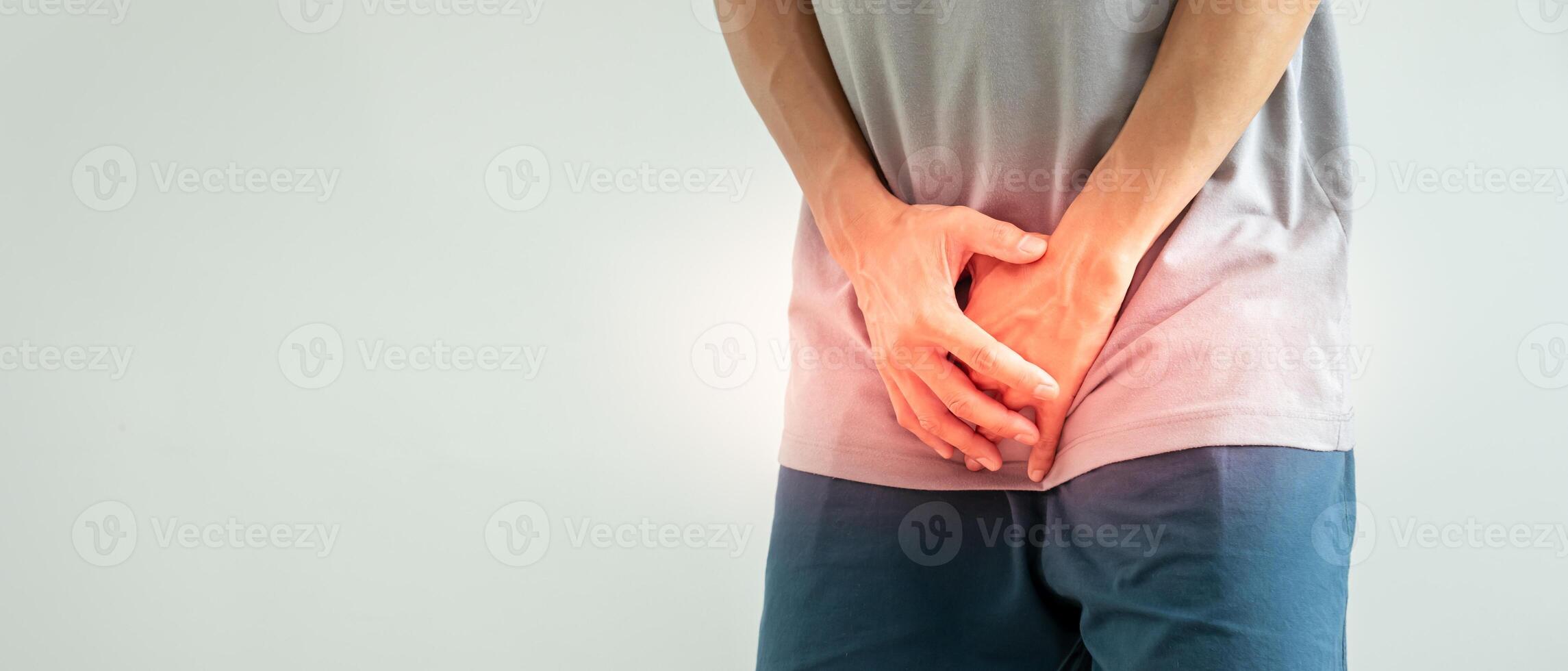 Man hold hand in front of private parts feeling discomfort from disease and inflammation. Venereal, testicular cancer. bladder problems, erectile dysfunction, premature ejaculation, prostate cancer photo