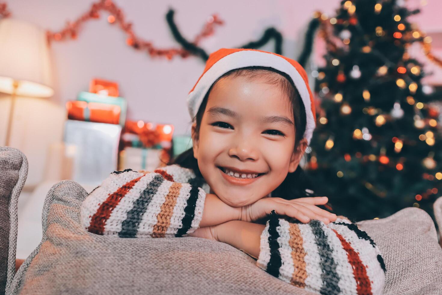 christmas, x-mas, winter, happiness concept - dreaming girl in santa helper hat photo