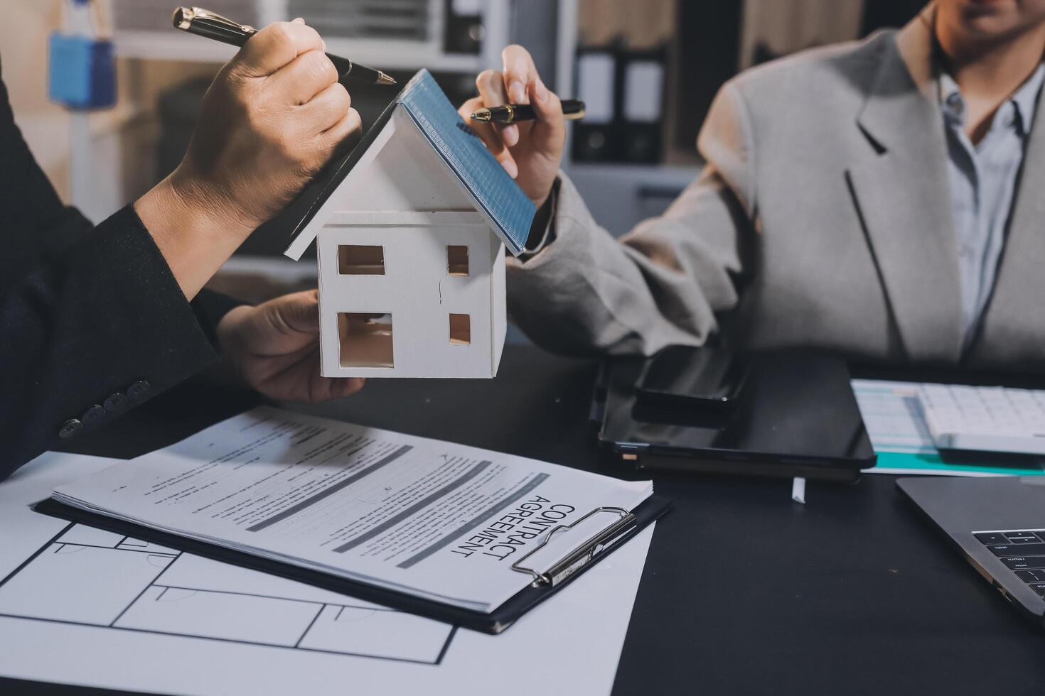 Close up Business people or Real Estate agent explain signing agreement for sale house to client. Property, Insurance, Broker concept. photo