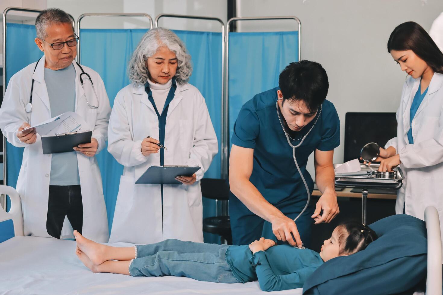 A team of doctors and nurses are working to treat a female patient in the patient's room. photo