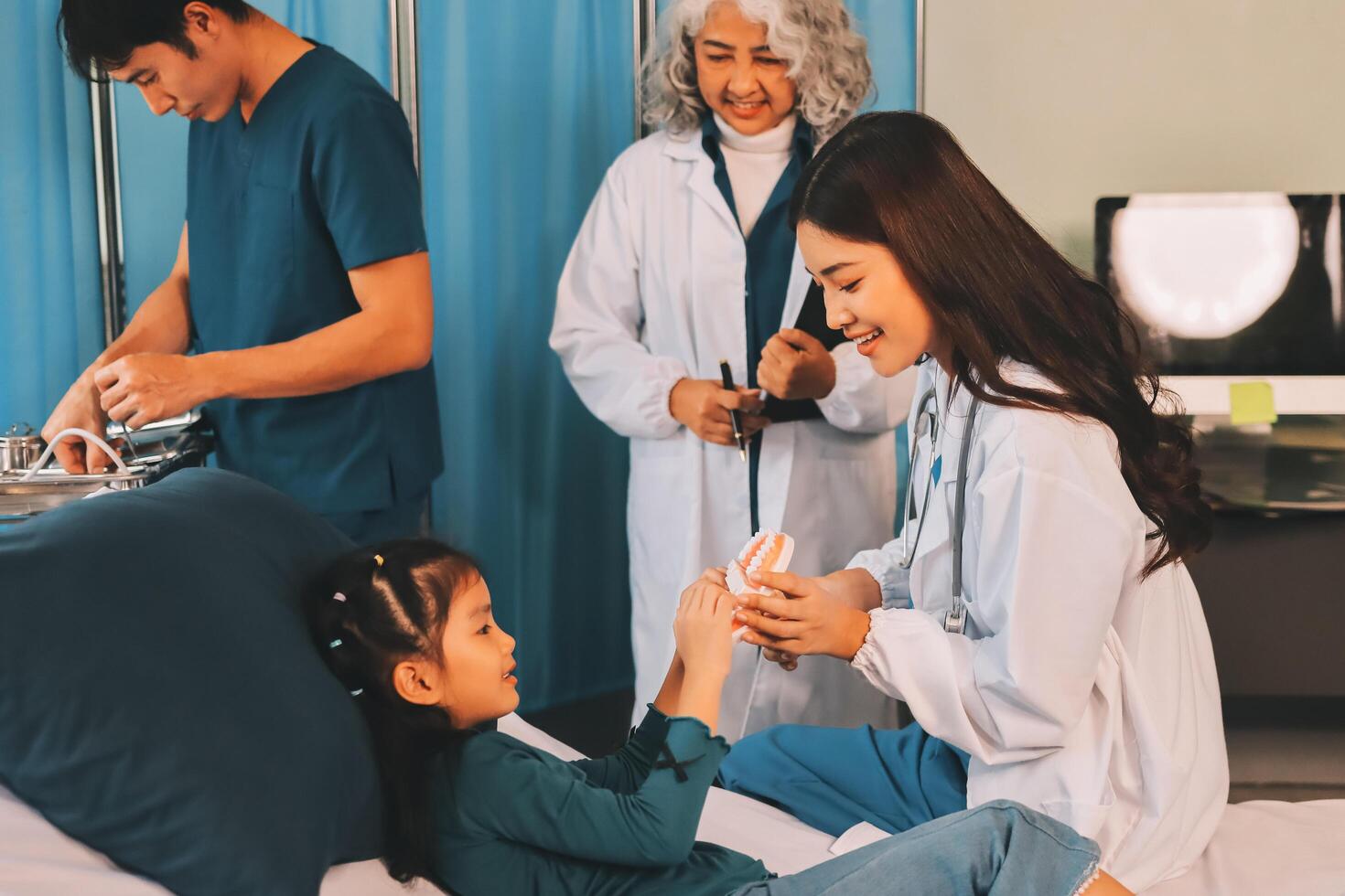 A team of doctors and nurses are working to treat a female patient in the patient's room. photo