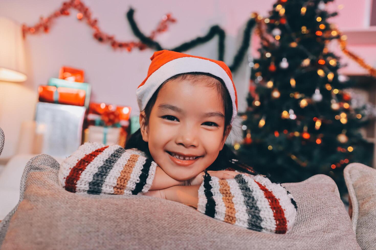 christmas, x-mas, winter, happiness concept - dreaming girl in santa helper hat photo