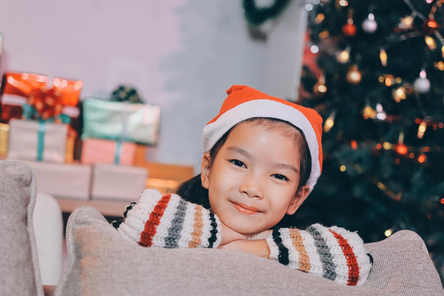 christmas, x-mas, winter, happiness concept - dreaming girl in santa helper hat photo