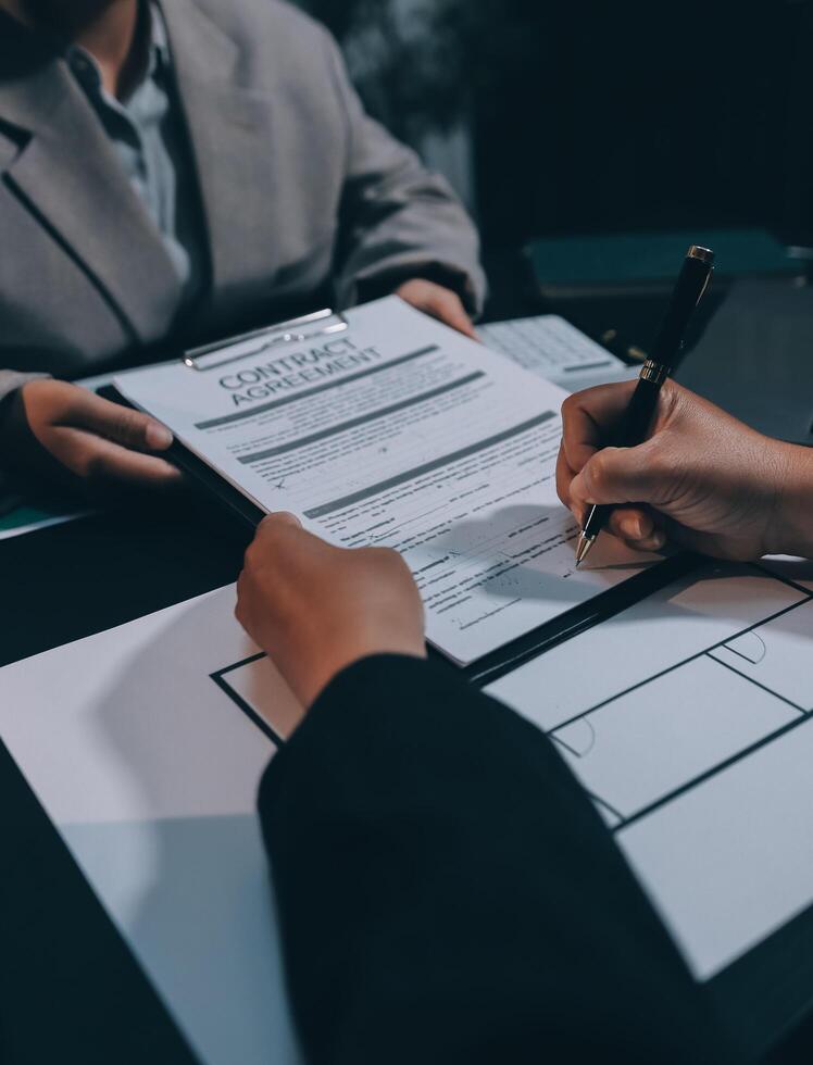 Close up Business people or Real Estate agent explain signing agreement for sale house to client. Property, Insurance, Broker concept. photo