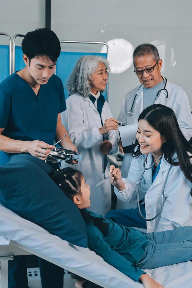 A team of doctors and nurses are working to treat a female patient in the patient's room. photo