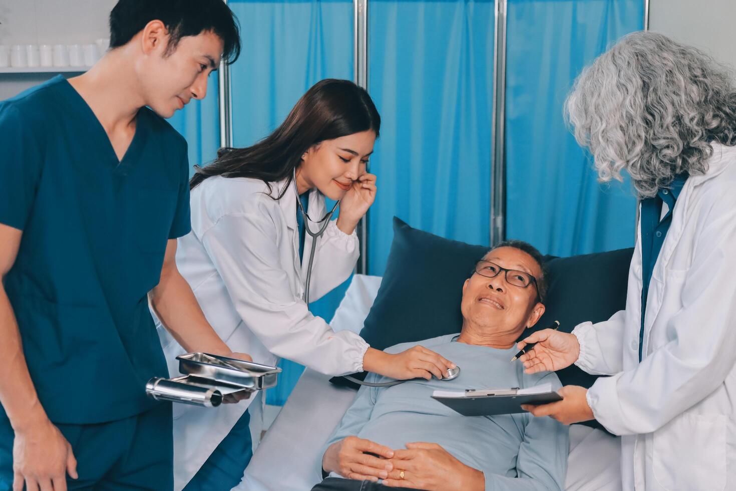 A team of doctors and nurses are working to treat a female patient in the patient's room. photo