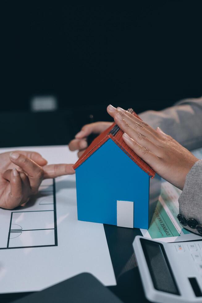 Close up Business people or Real Estate agent explain signing agreement for sale house to client. Property, Insurance, Broker concept. photo