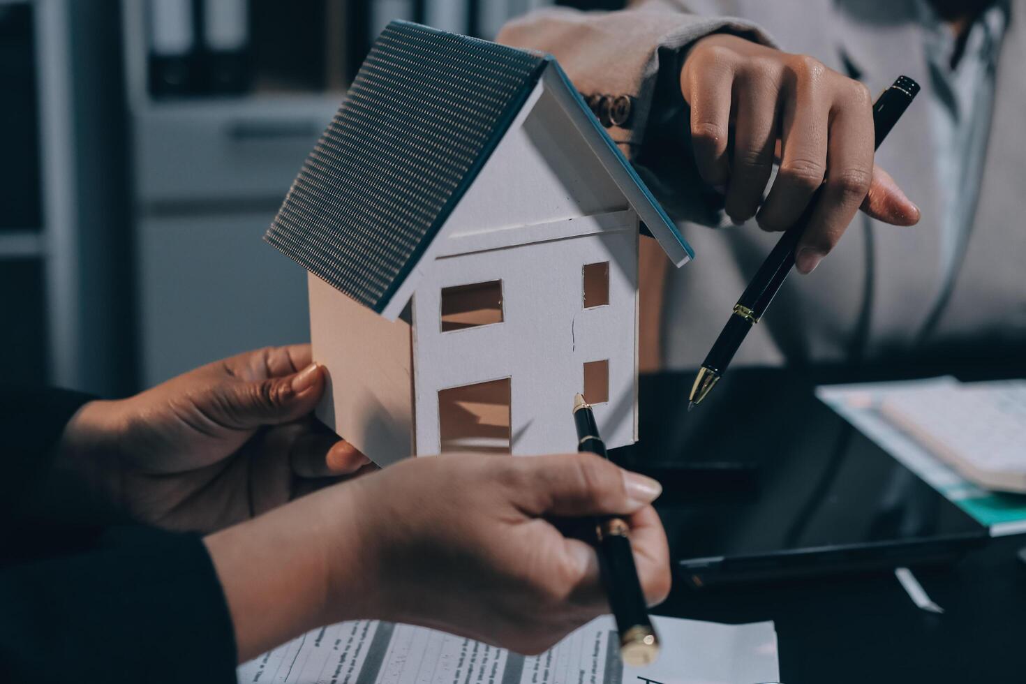 Close up Business people or Real Estate agent explain signing agreement for sale house to client. Property, Insurance, Broker concept. photo