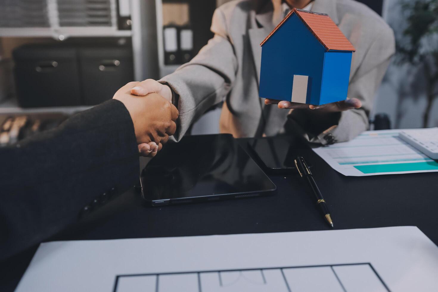 Close up Business people or Real Estate agent explain signing agreement for sale house to client. Property, Insurance, Broker concept. photo