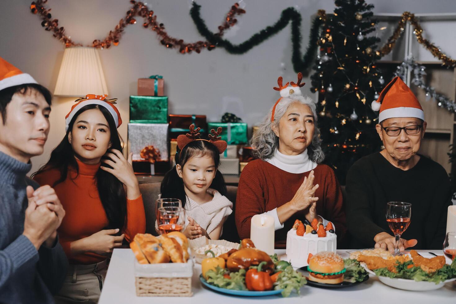 Happy multigeneration family enjoying in opening gifts on Christmas eve at home. photo