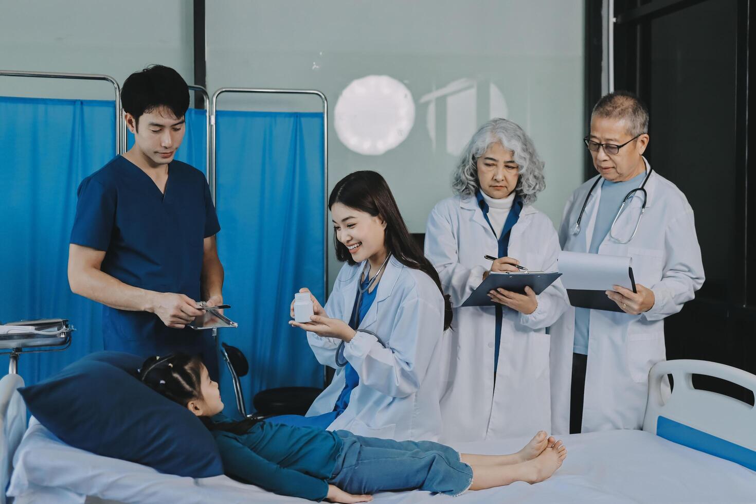 A team of doctors and nurses are working to treat a female patient in the patient's room. photo