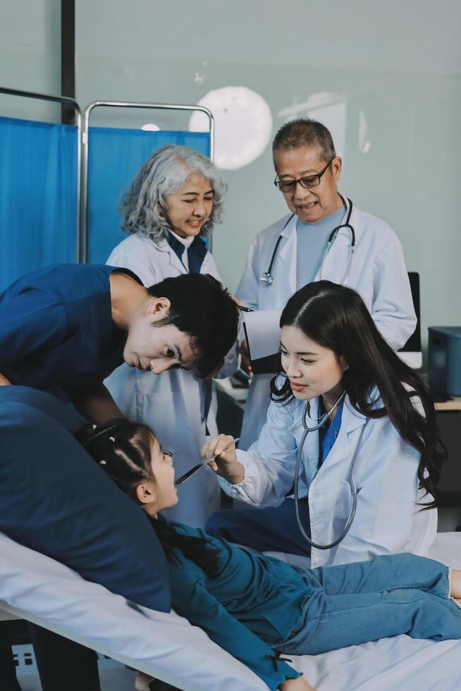 A team of doctors and nurses are working to treat a female patient in the patient's room. photo