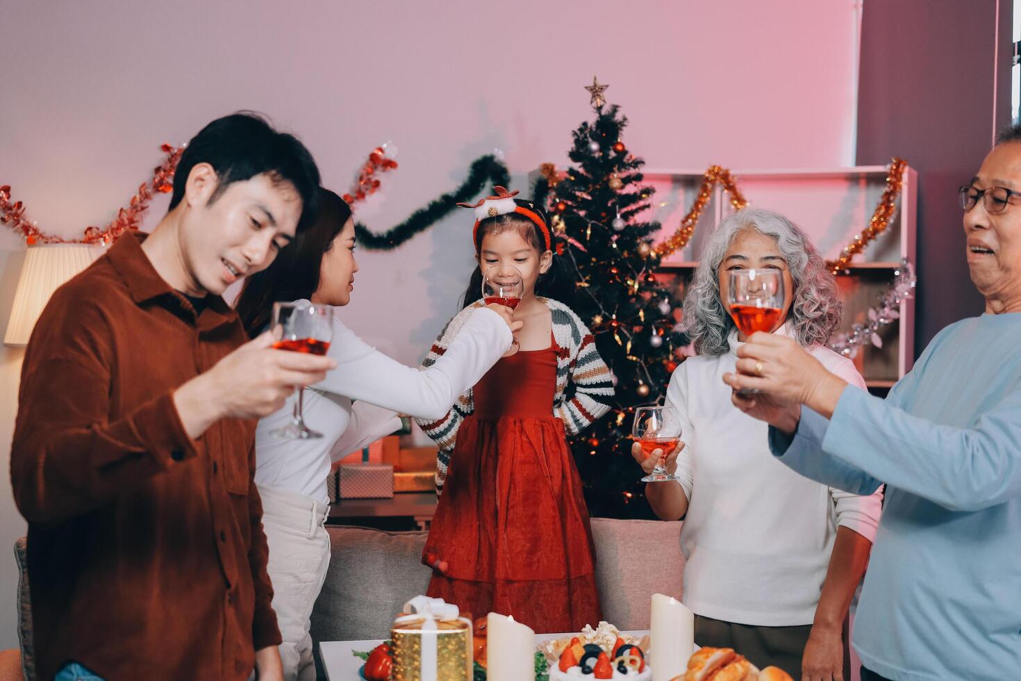 Merry Christmas Happy family are having dinner at home. Celebration holiday and togetherness near tree. photo