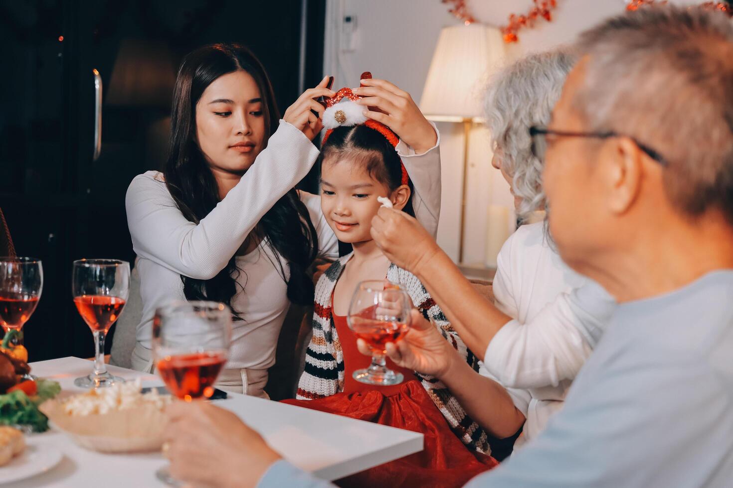 Merry Christmas Happy family are having dinner at home. Celebration holiday and togetherness near tree. photo