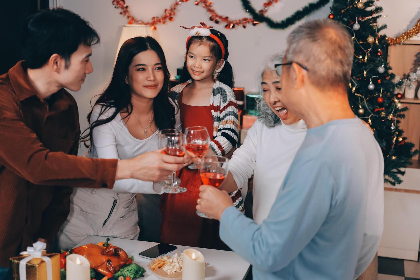 Merry Christmas Happy family are having dinner at home. Celebration holiday and togetherness near tree. photo
