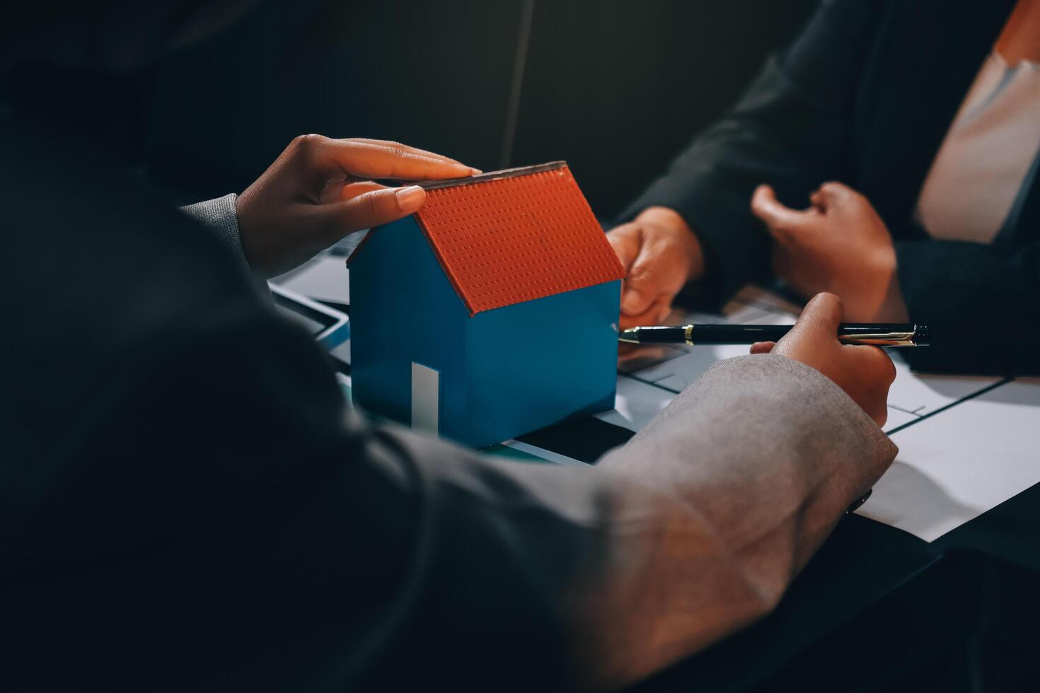 Close up Business people or Real Estate agent explain signing agreement for sale house to client. Property, Insurance, Broker concept. photo