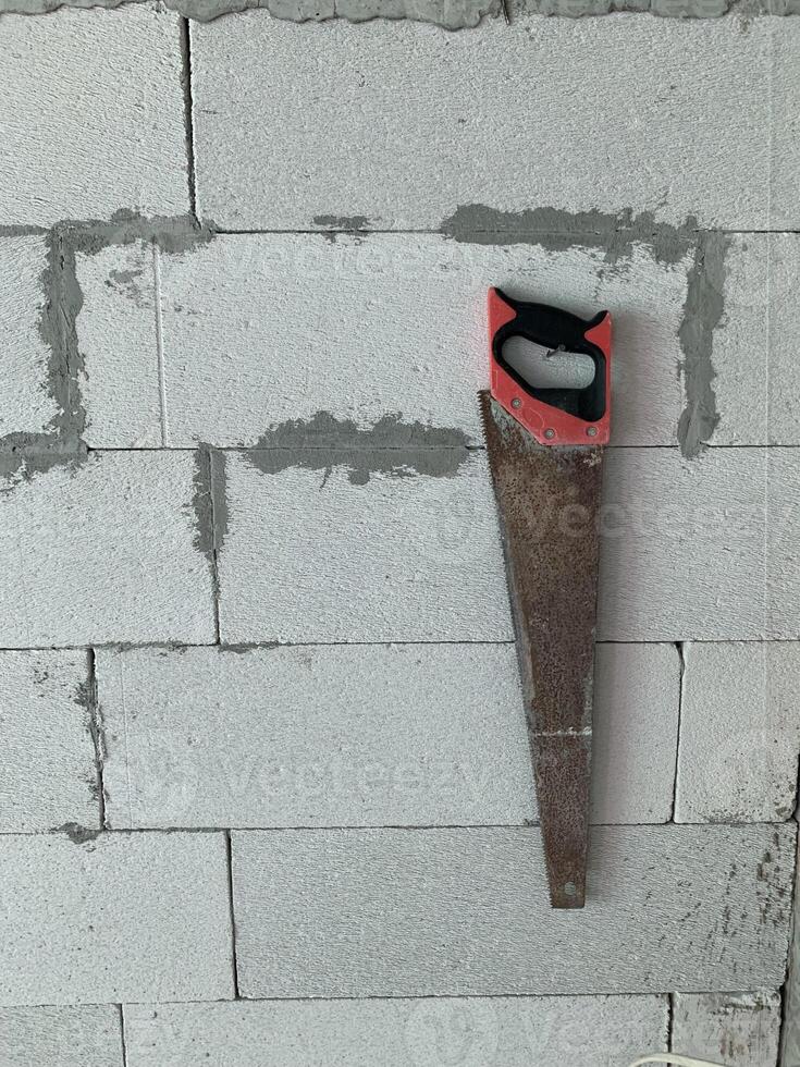 mannual saw on the floor in a building construction site background photo