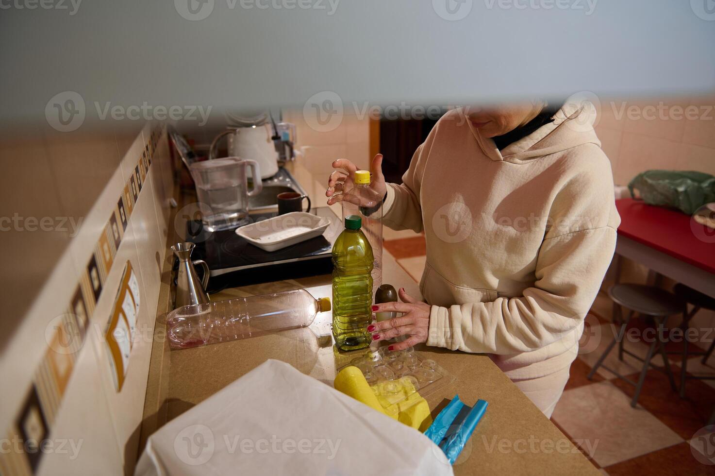 Person in a kitchen preparing items on a countertop photo