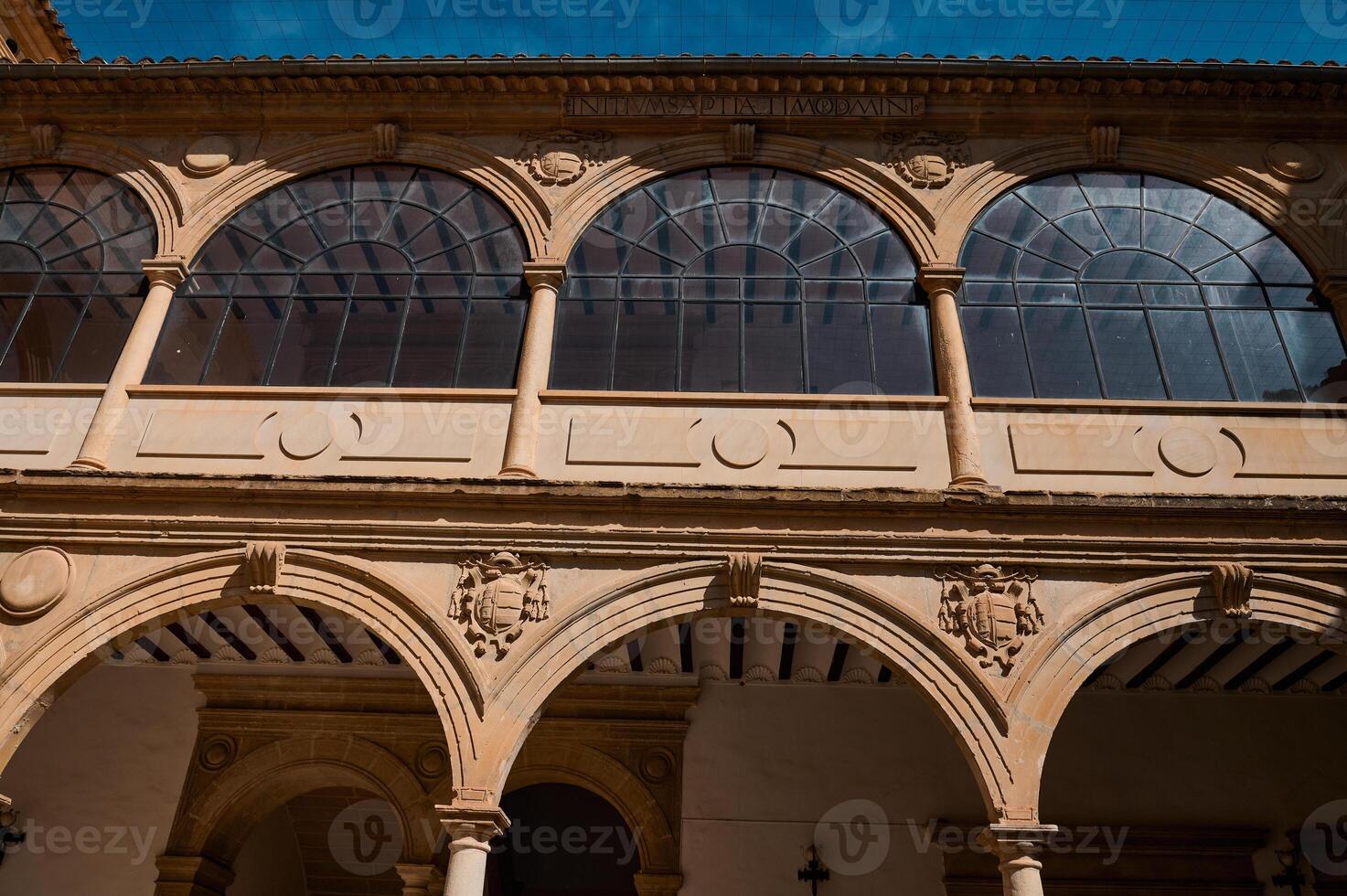 Historic architectural facade with arched windows and ornate details photo