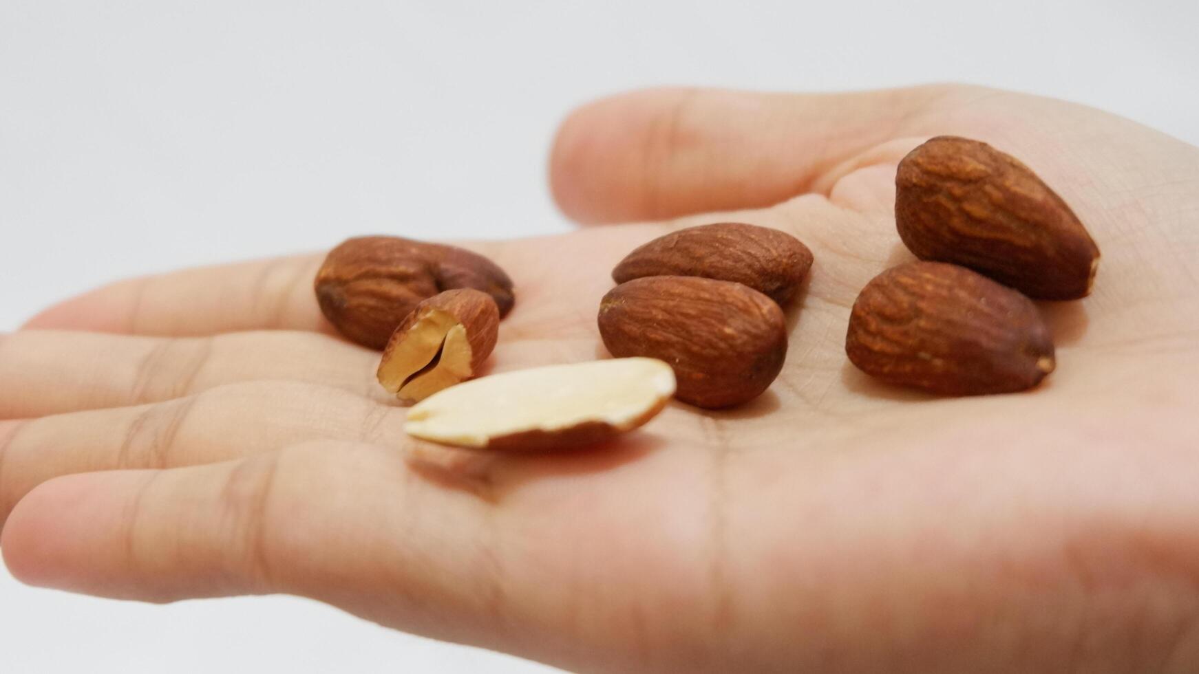 handful of nuts, almond isolated white background photo