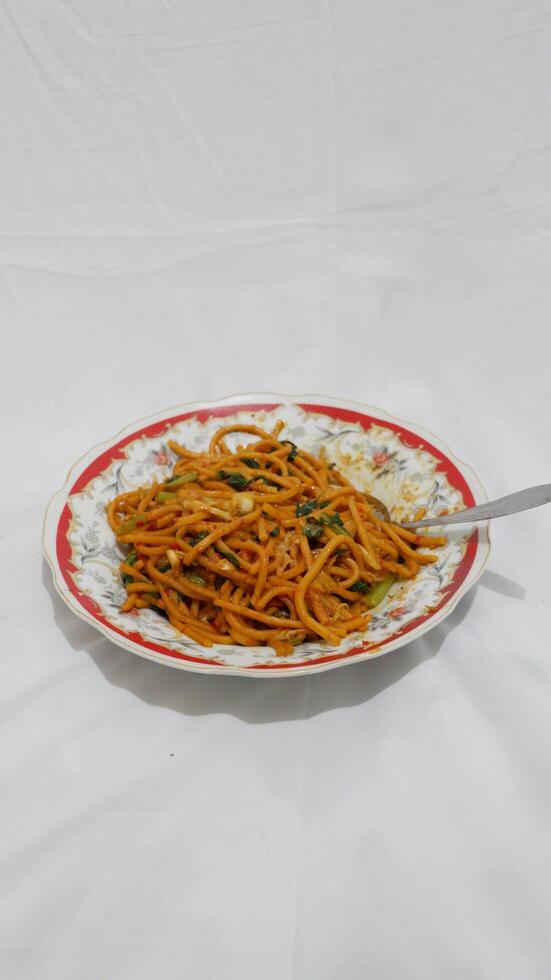 spaghetti with tomato sauce and basil, gomak noodles indonesian food photo