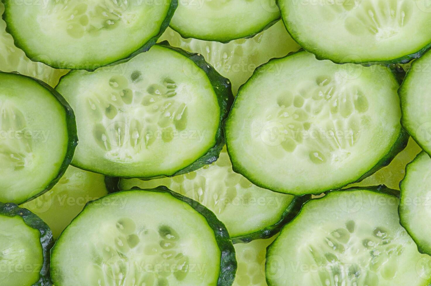 Cucumber slices as background. Vegetables cucumbers. photo