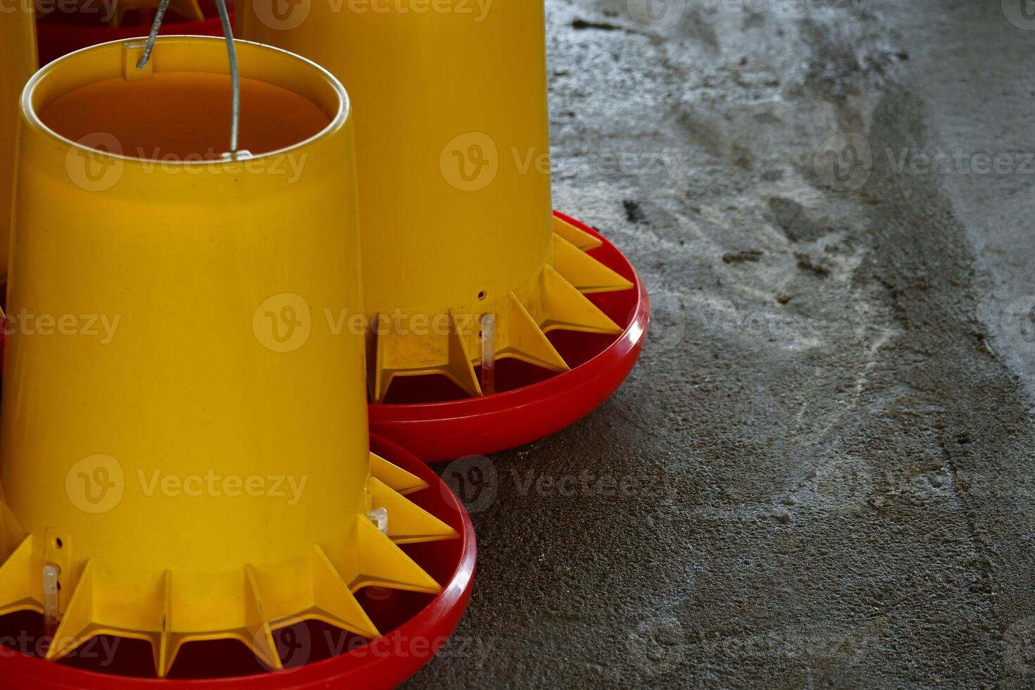 A group of yellow cones on a concrete floor photo