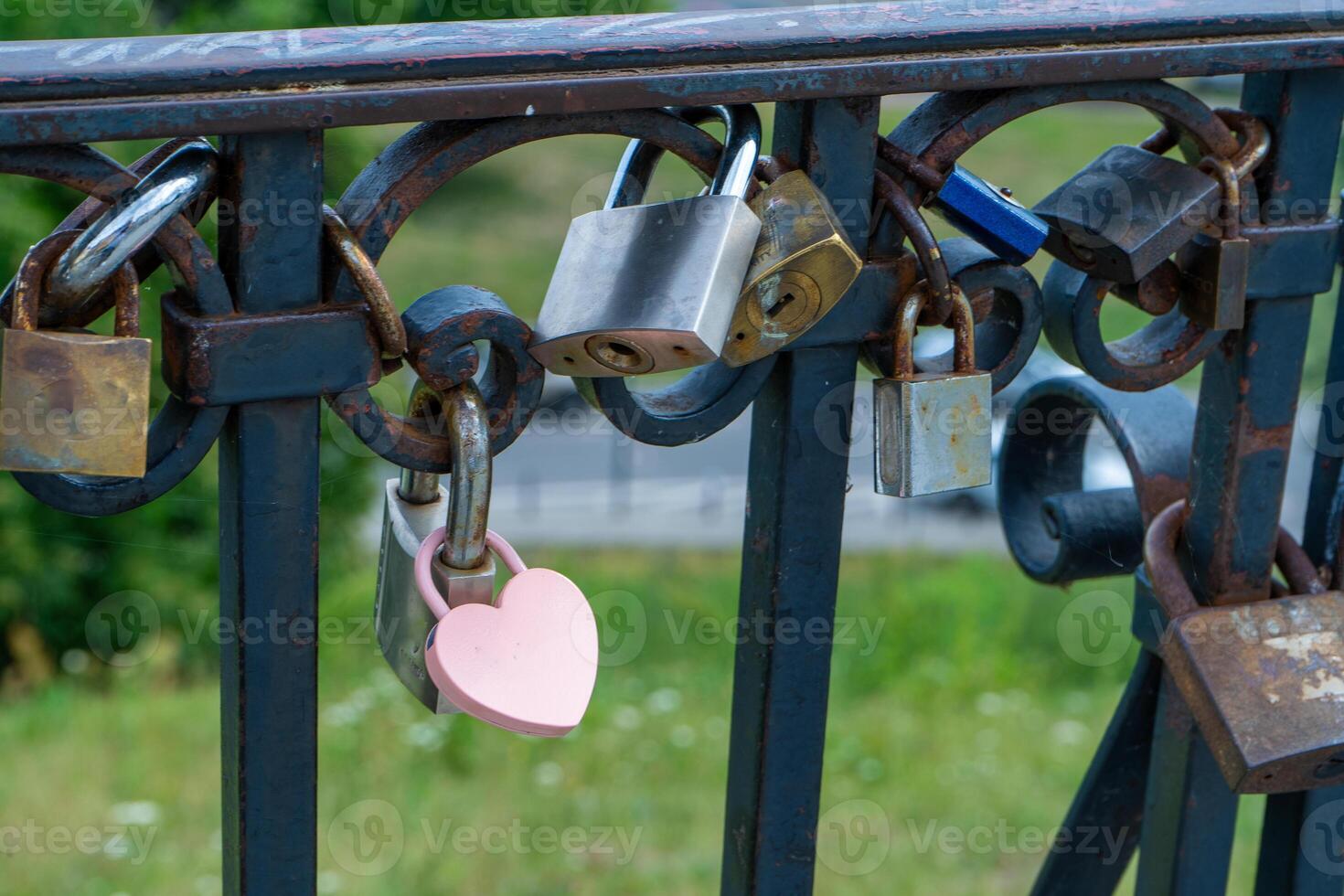 Pink lock in the shape of a heart. Locks for happiness, love and luck. Ritual and superstition. photo