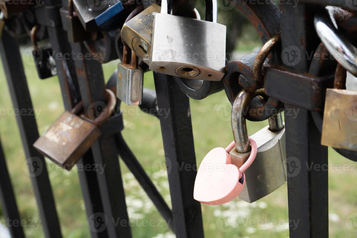 Pink lock in the shape of a heart. Locks for happiness, love and luck. Ritual and superstition. photo