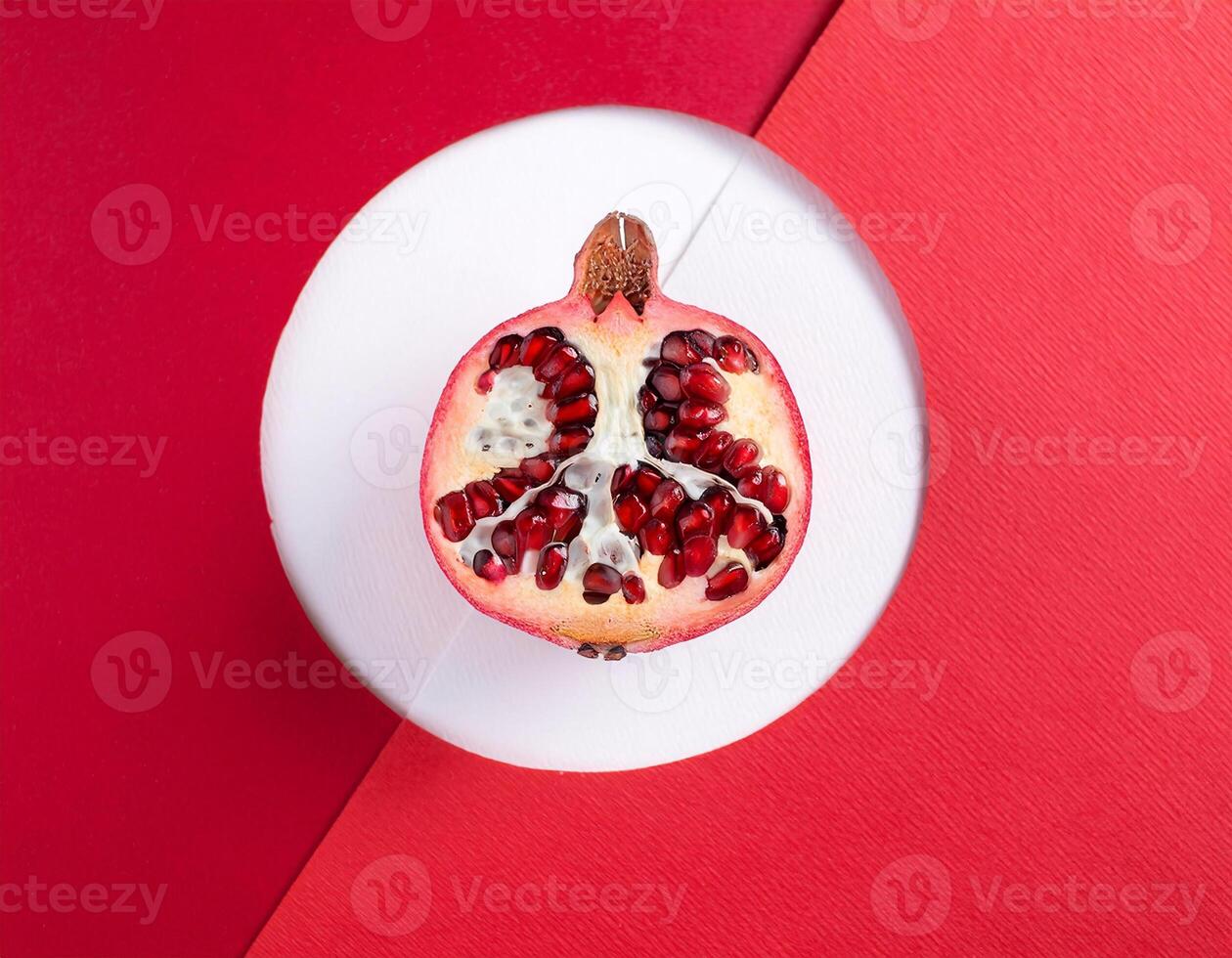 beautifully positioned pomegranates on a red and white background photo
